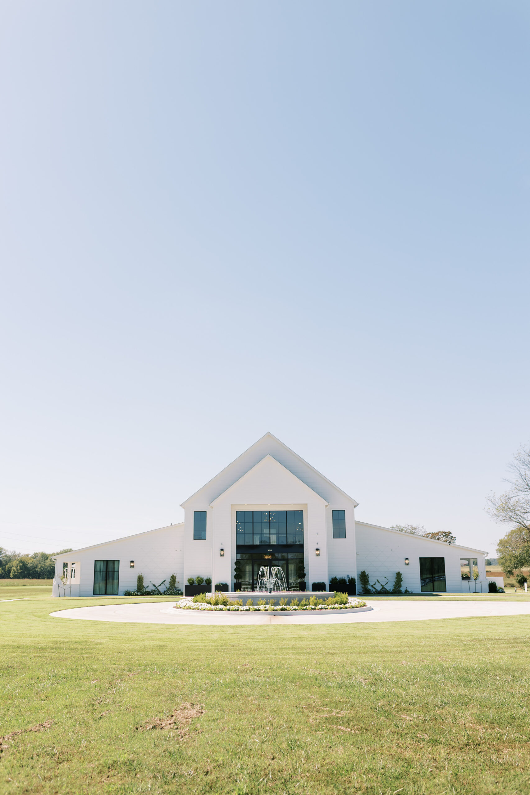 Bluestem Manor Venue showing building, 80 acres, and gorgeous fountain.